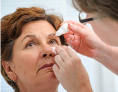 Picture of an Eye Dr putting drops in patients eye